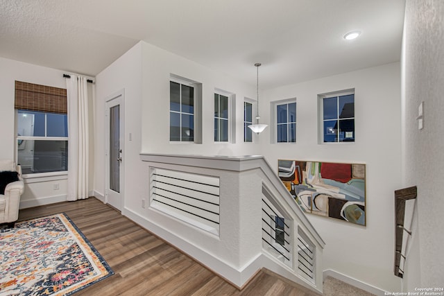 interior space featuring a textured ceiling and wood-type flooring