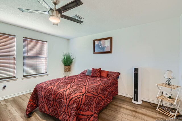 bedroom featuring hardwood / wood-style floors and ceiling fan