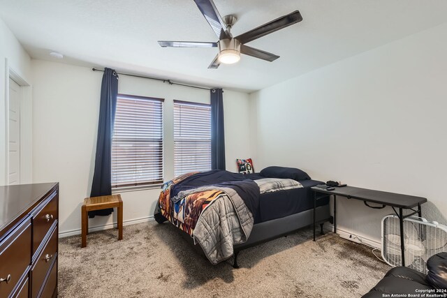 bedroom with light colored carpet and ceiling fan