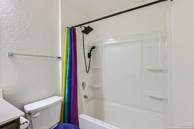 full bathroom with vanity, shower / tub combo with curtain, and toilet