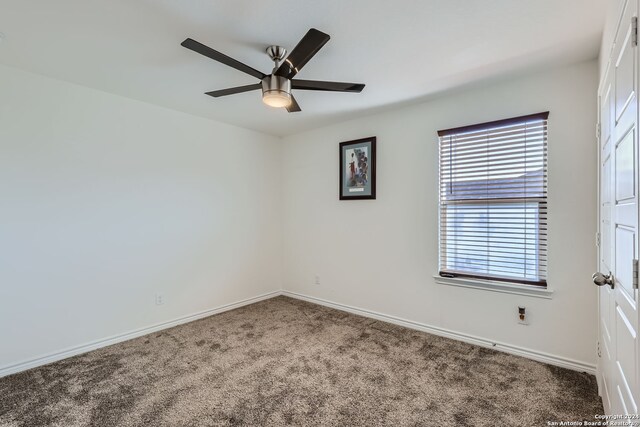 empty room with carpet flooring and ceiling fan