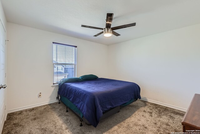 carpeted bedroom featuring ceiling fan