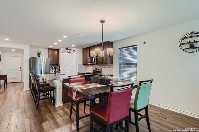 dining area with sink and dark hardwood / wood-style flooring