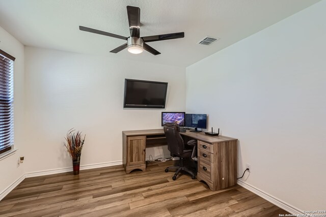 office space featuring hardwood / wood-style floors, a wealth of natural light, and ceiling fan