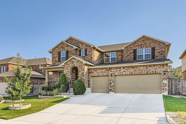 craftsman house featuring a garage and a front lawn