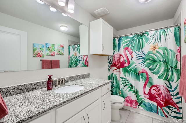 bathroom featuring vanity, a shower with shower curtain, toilet, and tile patterned floors