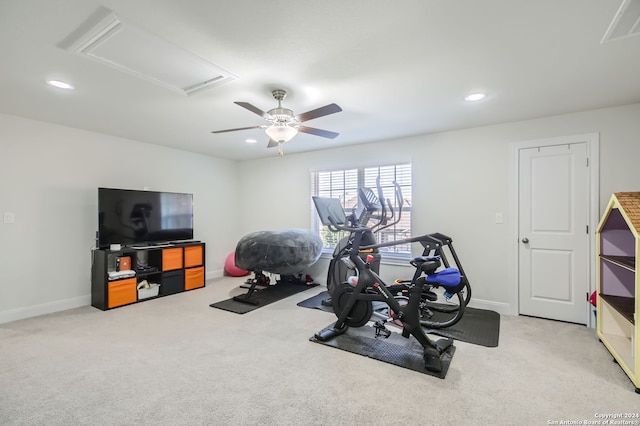 exercise area with ceiling fan and light colored carpet