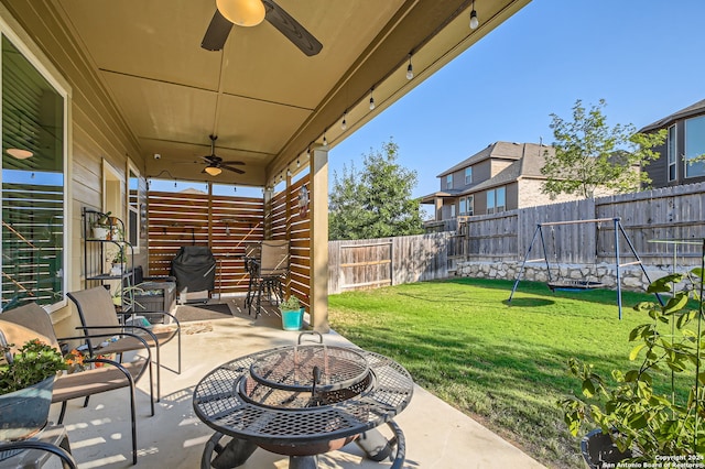 view of patio / terrace with an outdoor fire pit and ceiling fan