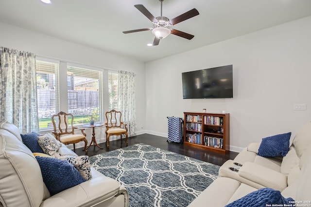 living room featuring ceiling fan and dark hardwood / wood-style floors