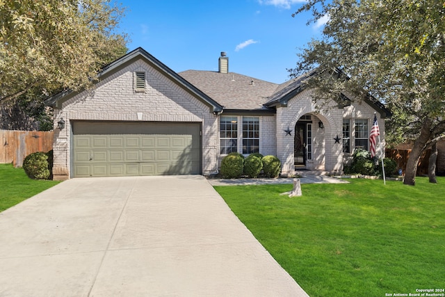 ranch-style house with a front yard and a garage