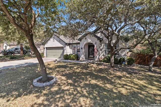 view of front facade featuring a front lawn and a garage