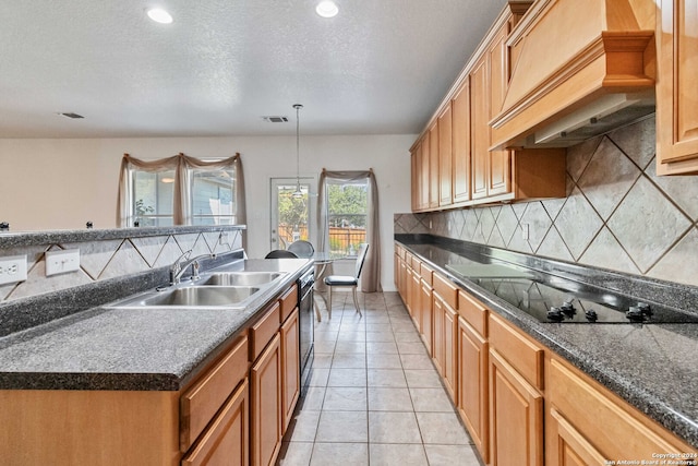 kitchen featuring black appliances, sink, a textured ceiling, light tile patterned floors, and premium range hood