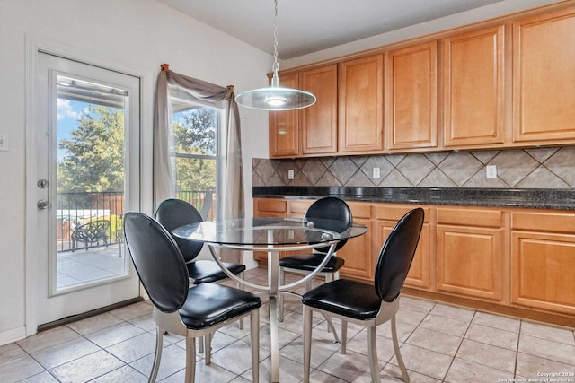 kitchen featuring tasteful backsplash, decorative light fixtures, and light tile patterned flooring