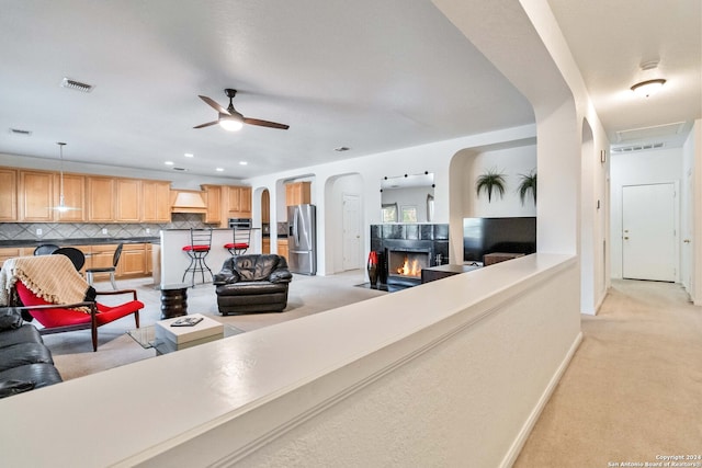 living room with light carpet and ceiling fan