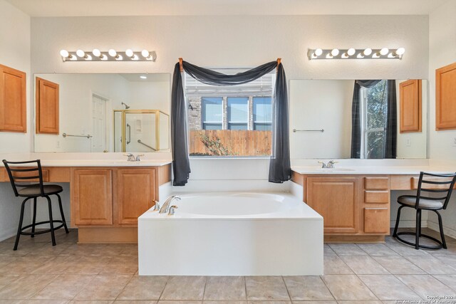 bathroom featuring vanity, tile patterned floors, and separate shower and tub