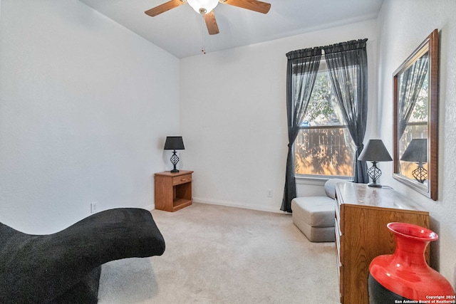 sitting room featuring ceiling fan and light colored carpet