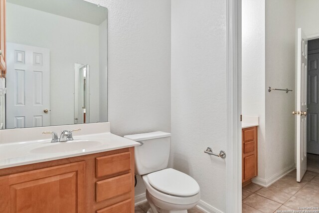 bathroom featuring vanity, toilet, and tile patterned floors