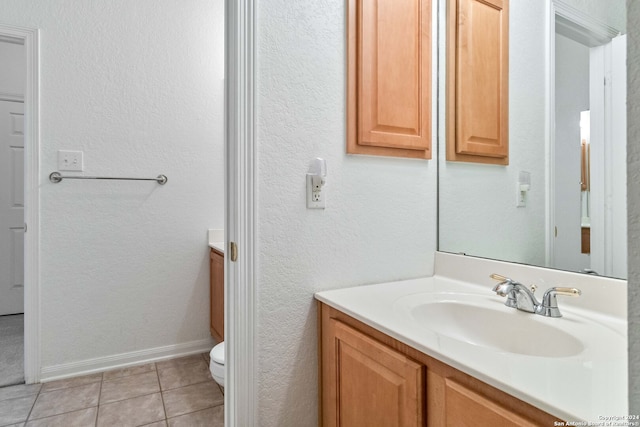 bathroom featuring vanity, toilet, and tile patterned flooring