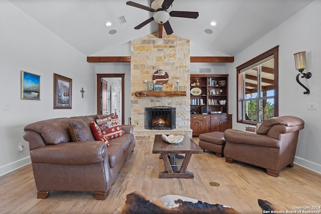 living room with ceiling fan, high vaulted ceiling, light wood-type flooring, and a fireplace