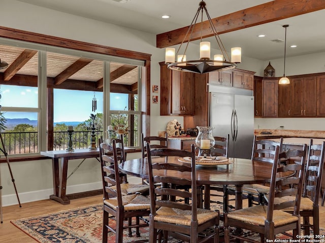 dining area featuring an inviting chandelier, light hardwood / wood-style flooring, a healthy amount of sunlight, and beamed ceiling