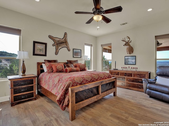 bedroom with light wood-type flooring and ceiling fan