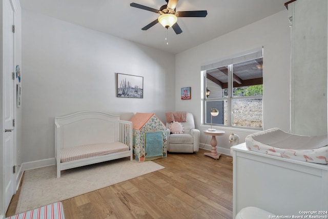 bedroom with ceiling fan and light hardwood / wood-style flooring