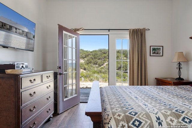 bedroom with french doors, hardwood / wood-style flooring, and access to outside