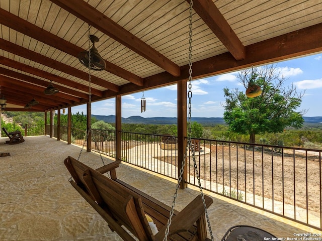 view of patio / terrace featuring a mountain view and ceiling fan