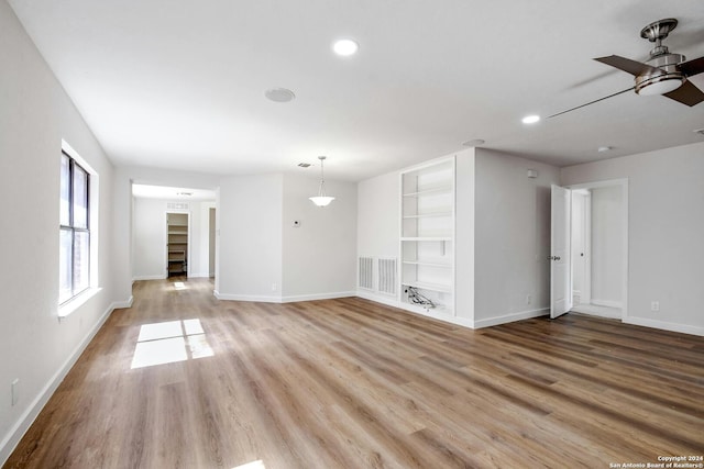 unfurnished living room featuring light hardwood / wood-style floors and ceiling fan