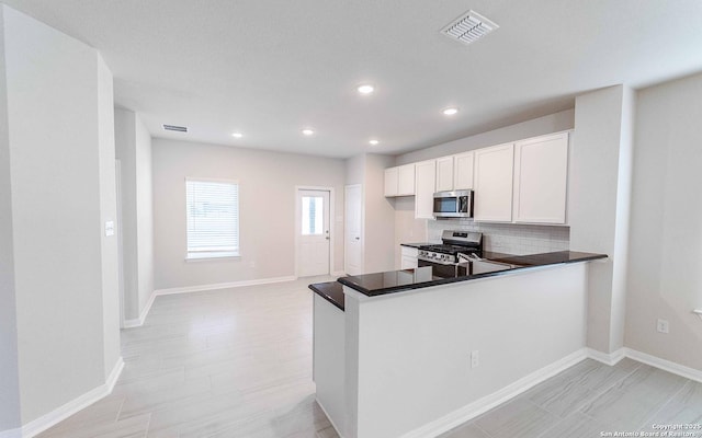 6523 Scooby Acres, San Antonio, TX 78253 - kitchen featuring appliances with stainless steel finishes, decorative backsplash, white cabinetry, recessed lighting, and baseboards