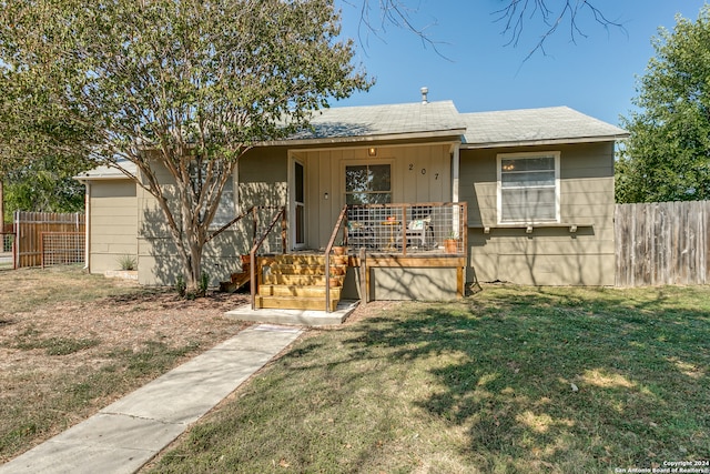 bungalow-style house with a front lawn and covered porch