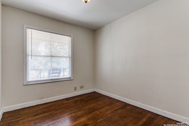 spare room featuring dark wood-type flooring