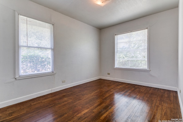 spare room featuring dark hardwood / wood-style floors