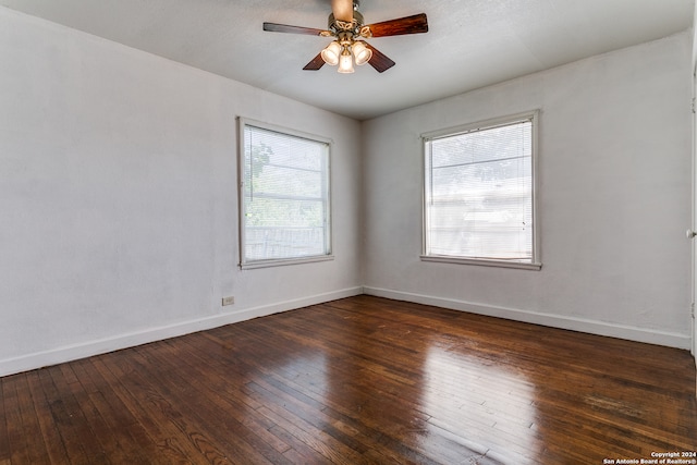 unfurnished room featuring dark hardwood / wood-style flooring, ceiling fan, and a wealth of natural light