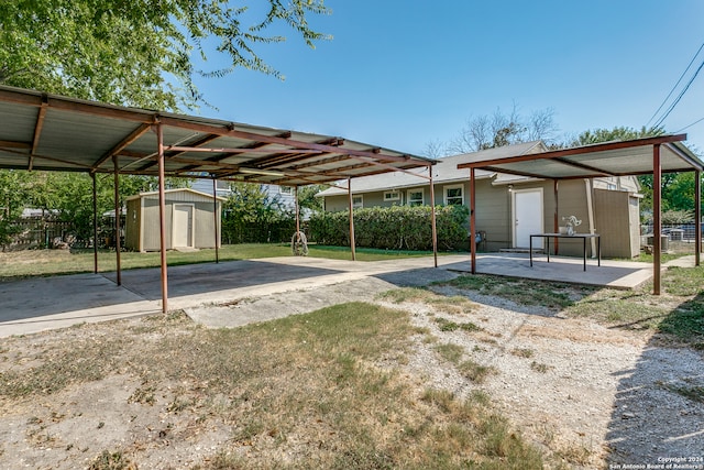 view of yard with a storage shed and a carport