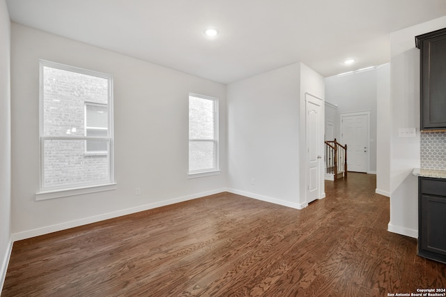 unfurnished room with dark hardwood / wood-style flooring