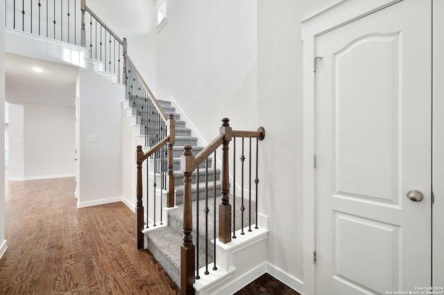 stairs featuring hardwood / wood-style floors