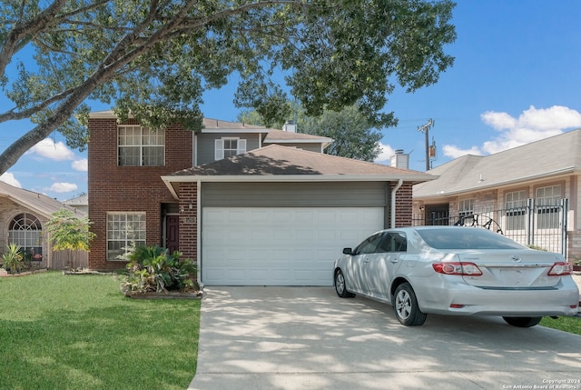 view of front of property featuring a front yard and a garage