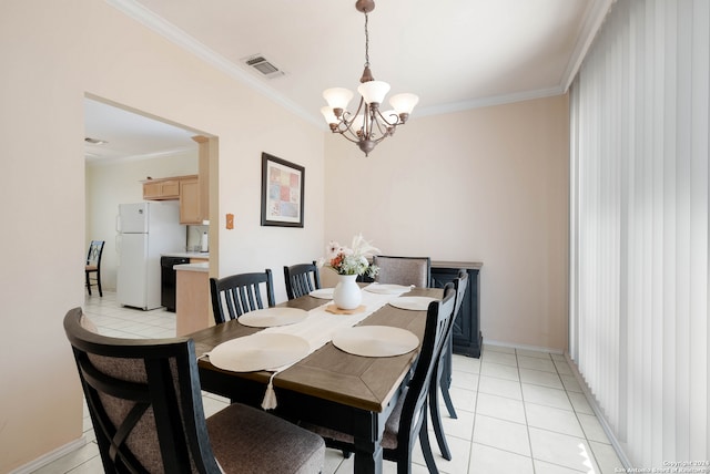 tiled dining area with crown molding and an inviting chandelier