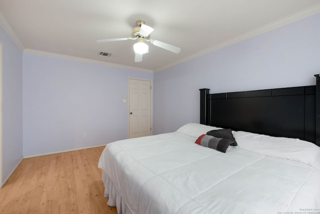 bedroom with light hardwood / wood-style floors, ornamental molding, and ceiling fan