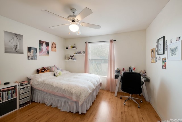 bedroom with light hardwood / wood-style floors and ceiling fan