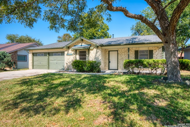 ranch-style home featuring a garage and a front lawn