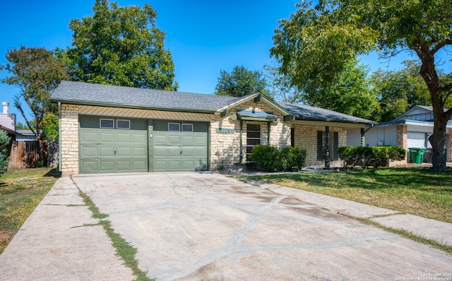 single story home featuring a front lawn and a garage