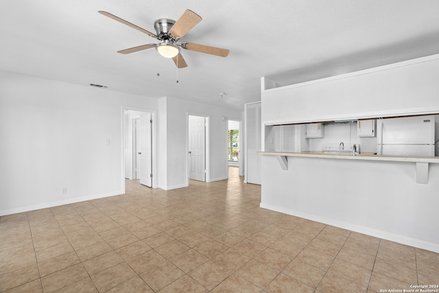 unfurnished living room featuring ceiling fan