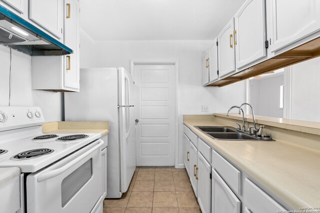 kitchen with sink, white range with electric stovetop, white cabinetry, and light tile patterned floors