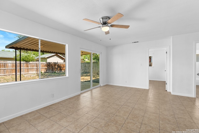 spare room featuring ceiling fan and light tile patterned floors