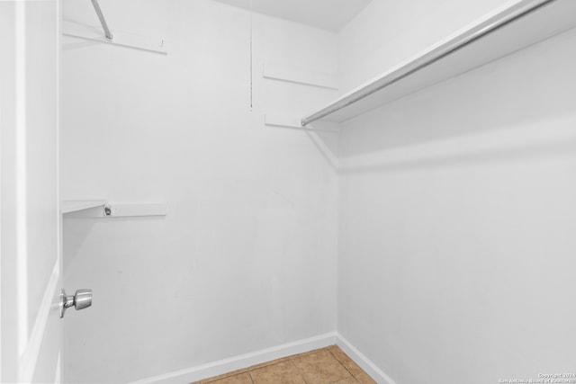 spacious closet with light tile patterned flooring