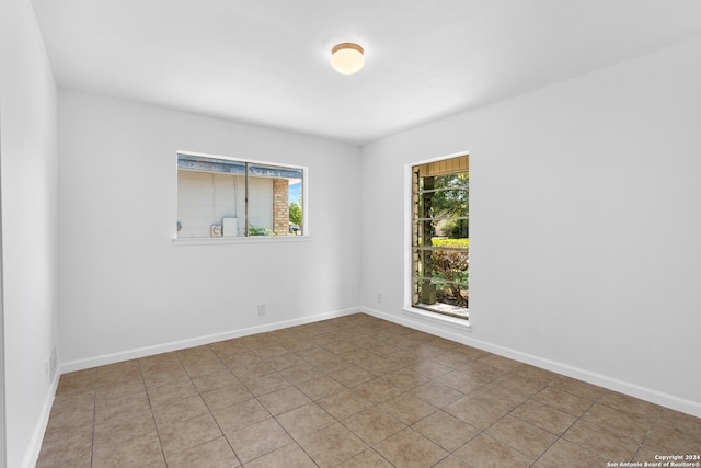 spare room with light tile patterned flooring