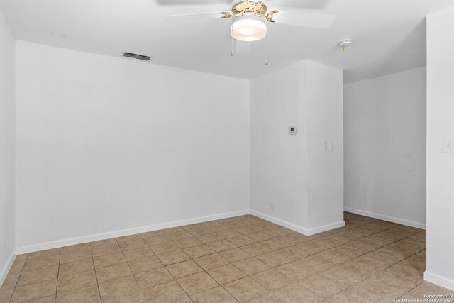 tiled empty room with ceiling fan