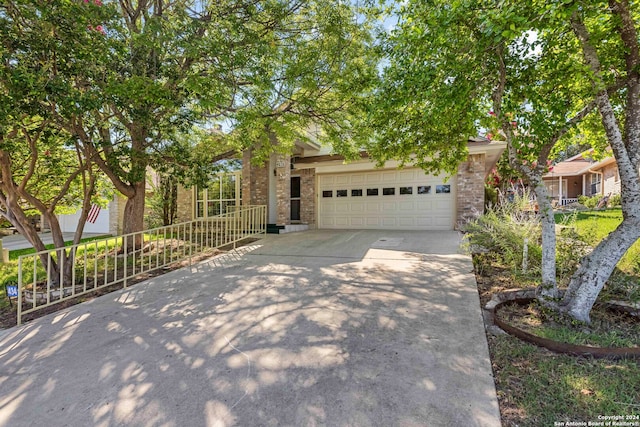 view of property hidden behind natural elements with a garage